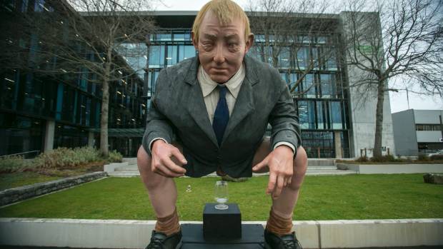 Giant statue of New Zealand’s environment minister doneing a poo left outside government offices