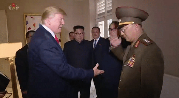 Donald Trump tries to shakes hands with a North Korean military leader